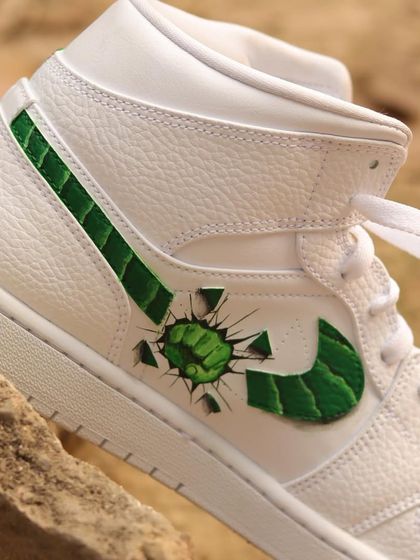 Hulk smash! This was one of my most challenging projects. I painted the Hulk breaking through the Nike swoosh on these Air Jordan 1s, which required careful alignment to create the 3D effect.