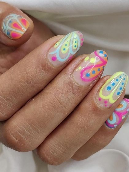 A close-up on the detailed dot work and layered colors of this abstract design. It's a testament to the precision and patience required for high-end nail art.