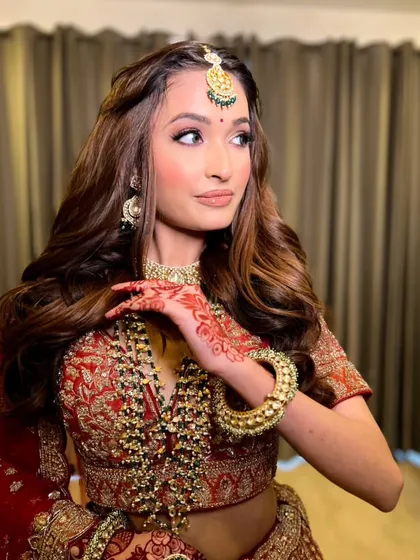 A side profile highlighting the beautiful hair and makeup. This look is perfect for any guest who wants to feel elegant and special.