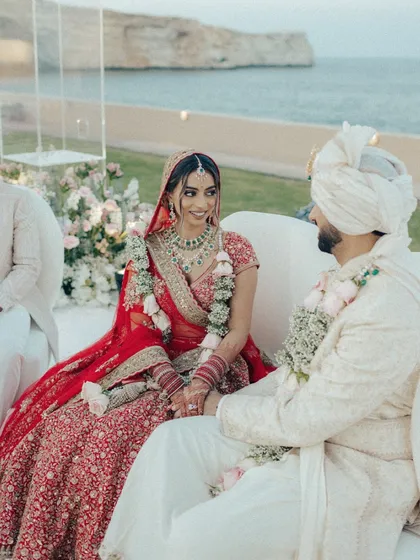 A smile shared between the bride and groom during their seaside ceremony. It's these unscripted, genuine moments that truly make a wedding.