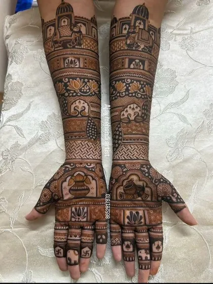 This traditional Indian bridal mehndi features auspicious symbols like the kalash and swastika, along with elephant and palace motifs, perfect for a wedding.