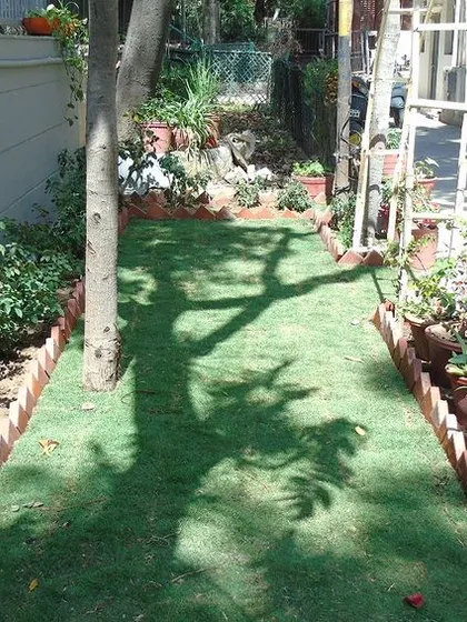 A simple backyard garden project can make a huge difference. We installed a strip of our artificial grass to create a neat and tidy lawn area, instantly greening up the space and making it more inviting.