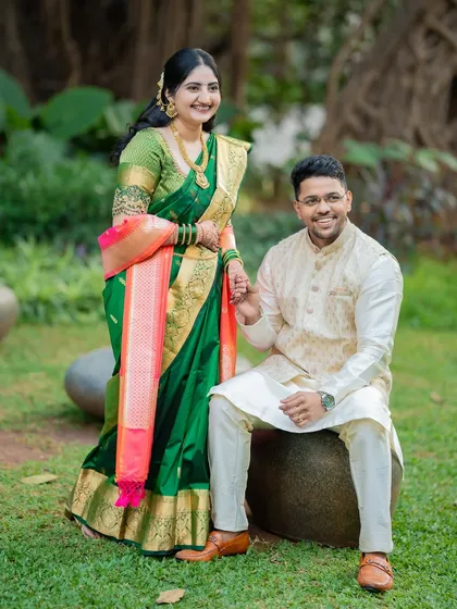 An elegant portrait of the couple in a garden. The composition is classic and timeless, perfect for a formal engagement announcement.