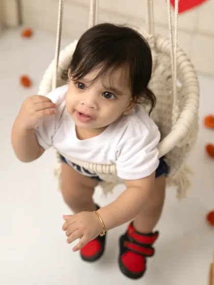 A curious little one enjoying the swing during his Raja Parba mini session.