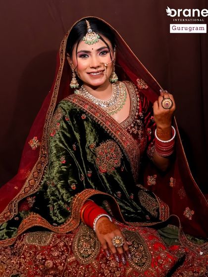 This look combines a traditional red lehenga with a contrasting velvet shawl. I teach students how to work with different fabrics and color combinations to create a cohesive look.