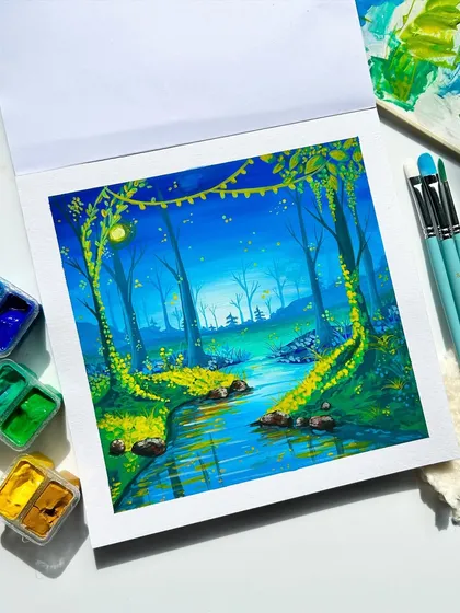 The finished magical forest painting, surrounded by my gouache paints and brushes. The glowing vines and serene stream make it feel like a wonderland.