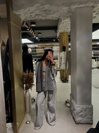 A wide shot of the grey outfit, showing how it looks in the context of the store.