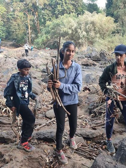 Participants gather firewood, learning another essential aspect of outdoor survival and campcraft.