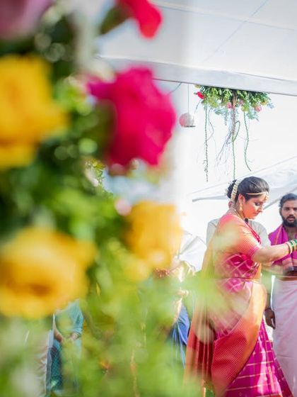 A guest is being helped during the wedding ceremony, a small act of kindness captured through a beautiful floral frame. We look for stories everywhere.