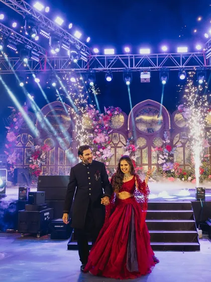 The couple makes their grand entrance onto the Sangeet stage, with cold pyros erupting around them, a moment of pure celebration and excitement.