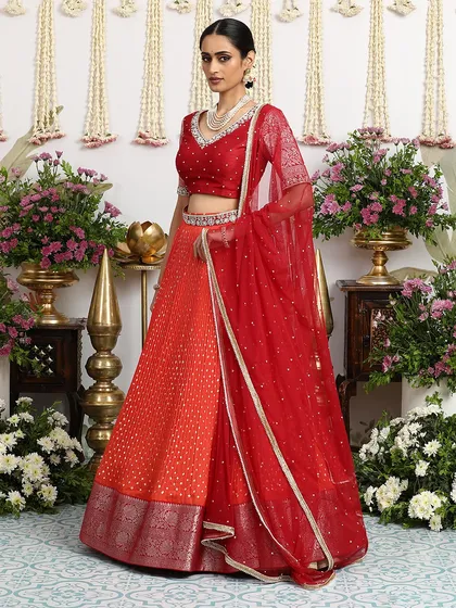 A side profile that highlights the elegant drape of the dupatta and the intricate details of the blouse.