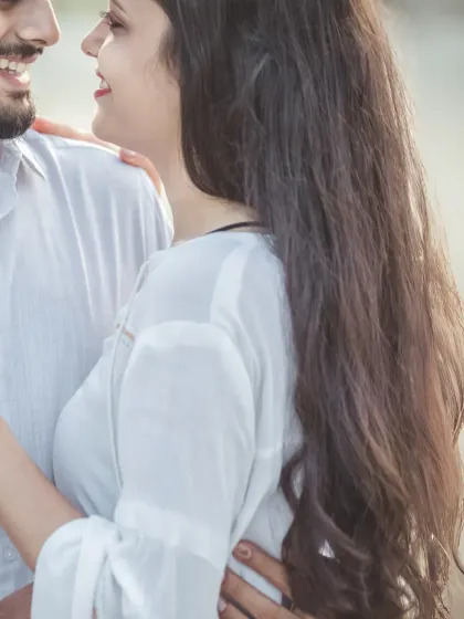 A close-up of the couple sharing a happy, intimate moment. The focus is entirely on their expressions and the connection they share.