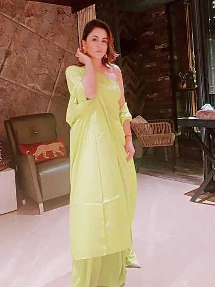 Don't be afraid of color. This vibrant neon green one-shoulder outfit is a modern take on festive wear. I help clients embrace bold hues and unique silhouettes that make them stand out at any celebration.