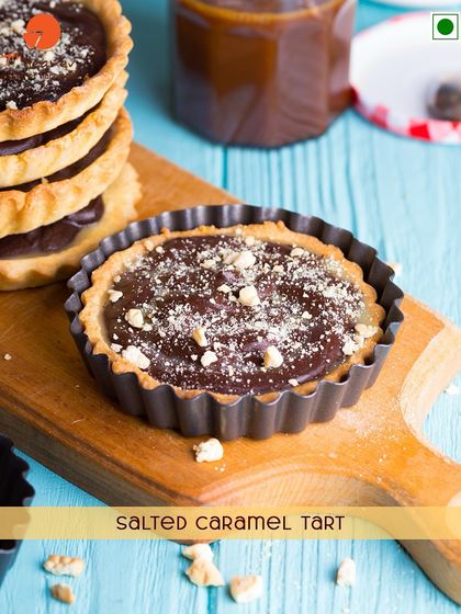 A delicious Salted Caramel Tart. This treat has a crisp pastry shell filled with a rich, gooey salted caramel and chocolate filling.