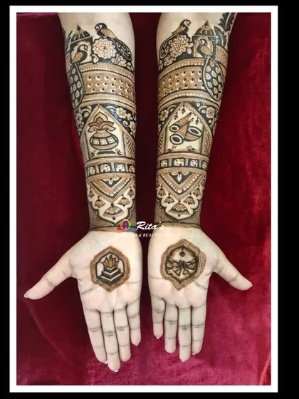 The back of the hands, showing how the intricate patterns continue from the front. The palms are left open here to feature small, significant symbols.