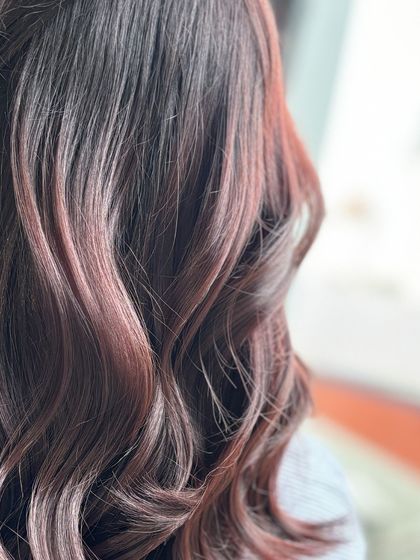 A close-up of the reddish-brown waves, showing the subtle highlights and beautiful texture.