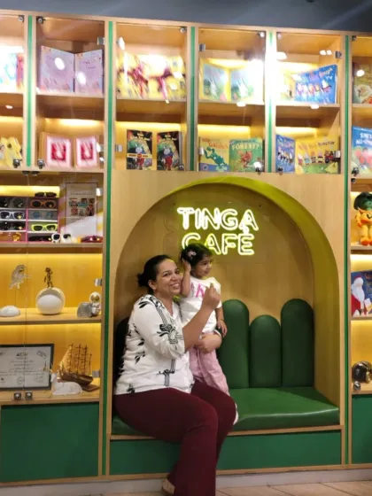 A mother and child share a happy moment at the Tinga Cafe, a great place to recharge during a fun-filled day.