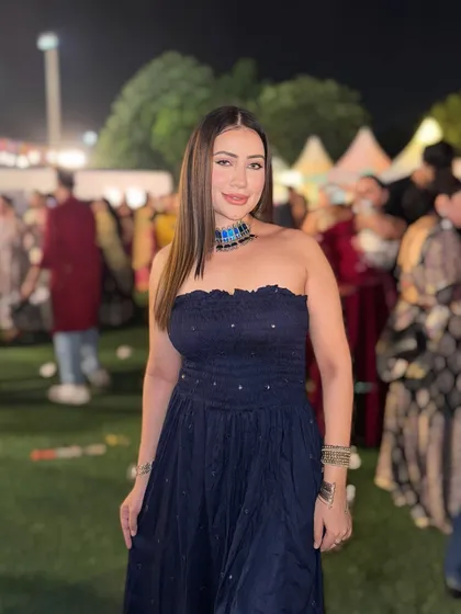 A strapless navy blue ethnic dress with silver embellishments, paired with a statement necklace for a Navratri event.