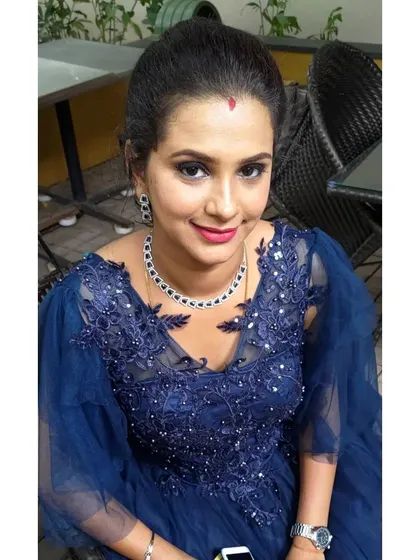 A perfect party look for a client celebrating her son's birthday. The focus is on a blue-toned smokey eye to match her gown, paired with a fresh, glowing complexion and a simple updo.