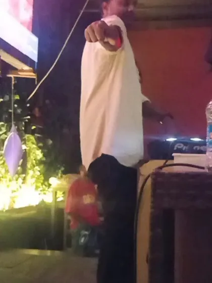 A candid shot of me interacting with the crowd from the DJ booth during an outdoor event.