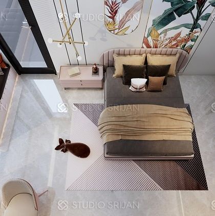 An overhead shot of the bedroom, showing the geometric-patterned rug and the well-planned layout that includes a window seat.