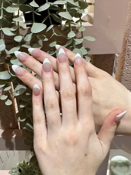 The epitome of elegance. A classic white French manicure on long, beautifully shaped almond nails.
