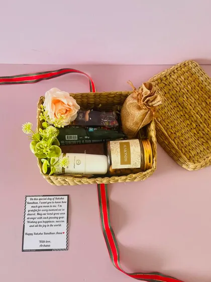 This cane box hamper was customized for Raksha Bandhan. It includes grooming items, chocolates, and a personalized card.