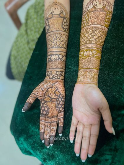 A unique shot showing one hand fully designed and the other bare, highlighting the transformative power of mehendi art.