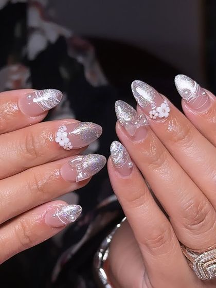 A stunning silver and white set with a cat-eye effect, delicate swirls, and 3D floral embellishments, perfect for a wedding or engagement party.