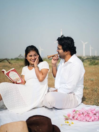 A playful moment during a picnic-themed pre-wedding shoot, filled with laughter and fun.