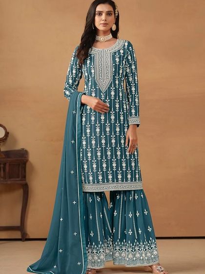 This teal salwar kameez is a classic. The white thread embroidery creates a stunning contrast, and the sharara pants add a modern, fashionable touch.