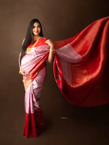 There is a unique grace in a traditional maternity photoshoot. This stunning mom-to-be wears a classic silk saree, and we captured the fabric in motion to create a dynamic and elegant portrait that celebrates her heritage.