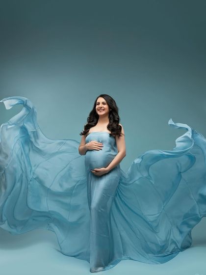 The full, glorious sweep of the blue gown. This wide shot shows the incredible drama and beauty we can create with fabric and light.