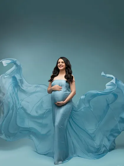 The full, glorious sweep of the blue gown. This wide shot shows the incredible drama and beauty we can create with fabric and light.