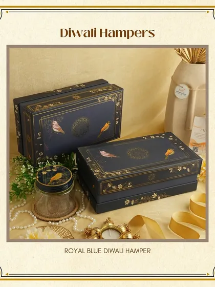 The 'Royal Blue' Diwali Hamper. This stunning hamper features book-style boxes with elegant bird motifs, offering a unique and sophisticated packaging option for your festive gifts.
