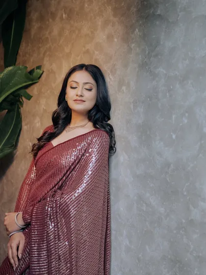A serene and elegant portrait, with the bride leaning against a textured wall.