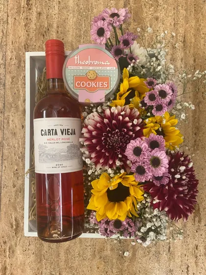 A lovely combination of wine, cookies, and a colorful bouquet of sunflowers and dahlias, perfect for an anniversary or a romantic surprise.