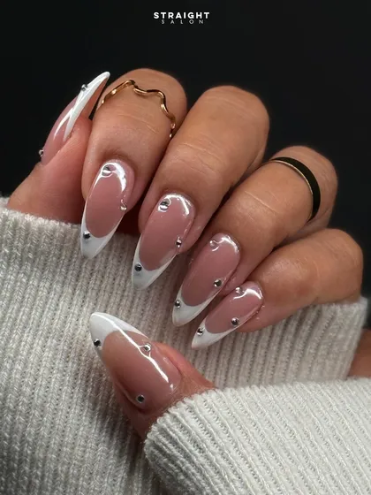 A modern take on a classic. This is my signature almond-shaped French manicure, elevated with precisely placed silver studs for a touch of edgy elegance and a flawless, clean finish.