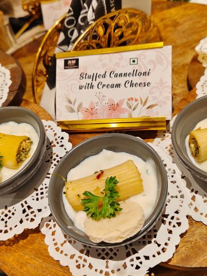 Stuffed Cannelloni with Cream Cheese, served in individual bowls on delicate doilies. This is a rich and satisfying appetizer, perfect for a formal sit-down dinner or an elegant buffet.