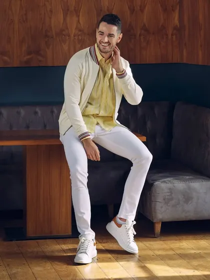 A fresh and clean look for Basics Life. We paired crisp white jeans with a light yellow striped shirt and an off-white bomber jacket. This is a great example of styling lighter colors for a sophisticated menswear look.
