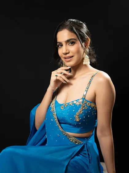A seated portrait in the blue gown. The intricate embroidery on the blouse adds a touch of sparkle.