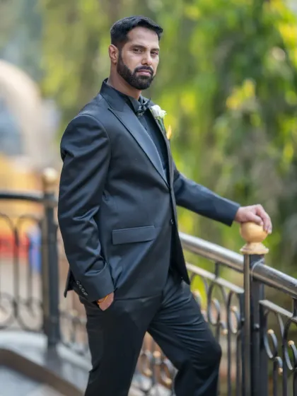 A classic, confident groom portrait. The outdoor setting and his relaxed pose make for a great, natural-looking shot.