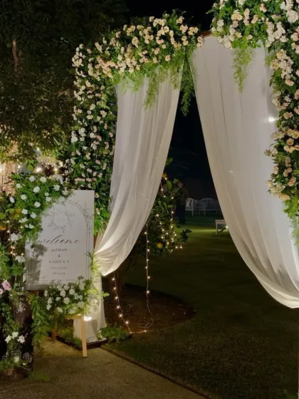 A romantic garden entrance for an outdoor wedding. I created a beautiful archway of white and pink florals, with a personalized welcome sign to greet the guests as they arrive.