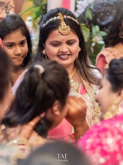 The bride surrounded by her family, sharing final words and moments before she departs. I capture the entire scene to show the circle of love supporting her.