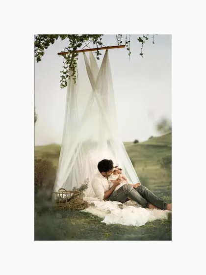 A quiet, loving moment as a father holds his baby daughter close, their faces touching. The peaceful outdoor setting and their gentle embrace create a deeply emotional and tender portrait.