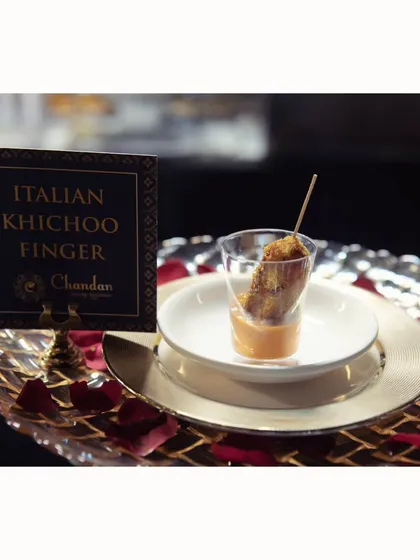 Italian Khichoo Finger, a creative fusion dish that combines the comfort of Gujarati khichu with Italian herbs and spices, served as a crispy finger food with a dipping sauce.