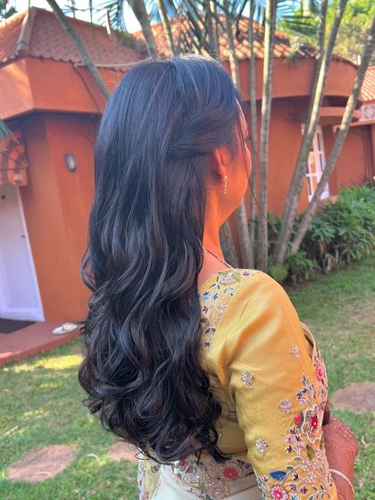 A classic half-updo with soft waves, a timeless and elegant choice.