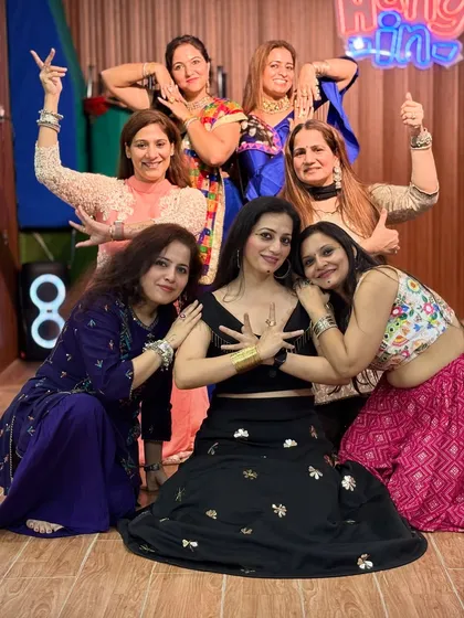 In sync with tradition and loving every moment. Our ladies' group poses after putting their hearts into a vibrant dance performance.