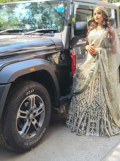 A full-length view of the black and silver lehenga, showing off its beautiful flare and intricate design. A perfect second hand designer outfit.