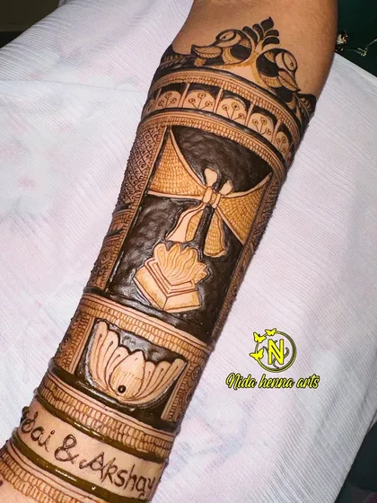 A close-up of the arm design, showing the sacred fire symbol, representing the wedding vows.